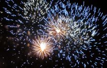 Fireworks - 2 blue yellows bursts against dying big blue burst