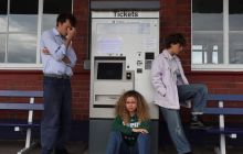 The cast at a railway station to dramatise a scene from No Time For Strangers 