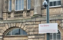 Edinburgh Trams sign at the Shore closeup with Georgian brickwork in background