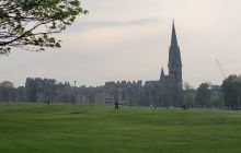 Dusk settles on Bruntsfield Links with the spire of Barclay Church rising high in the distance across the green