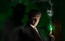 Performer Noel Byrne looks moodily to the front, set in a dark atmsophere with a spooky feel