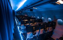 Moody blue lighting shows rows of seats in an airplane.