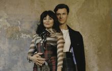 Stars Frances Ruffelle and Norman Bowman pictured in each others arms, looking at the camera. Ruffelle is wearing a rock-ish outfit; Bowman is wearing a leather jacket and a kilt.