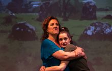 Two of the actors hug on stage - Annie Lareau, Brenda Joyner