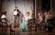 The Cast of The Seagull looking at each other jovially in the opening scene as they watch a performance