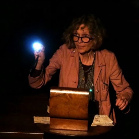 Maria MacDonell is pictured with a light, looking over the sewing box that contains Miss Lindsay's letters.