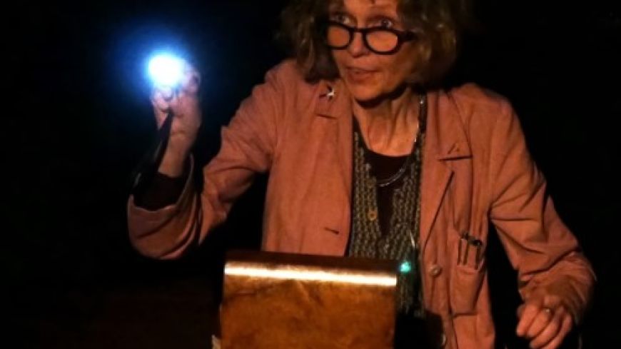 Maria MacDonell is pictured with a light, looking over the sewing box that contains Miss Lindsay's letters.