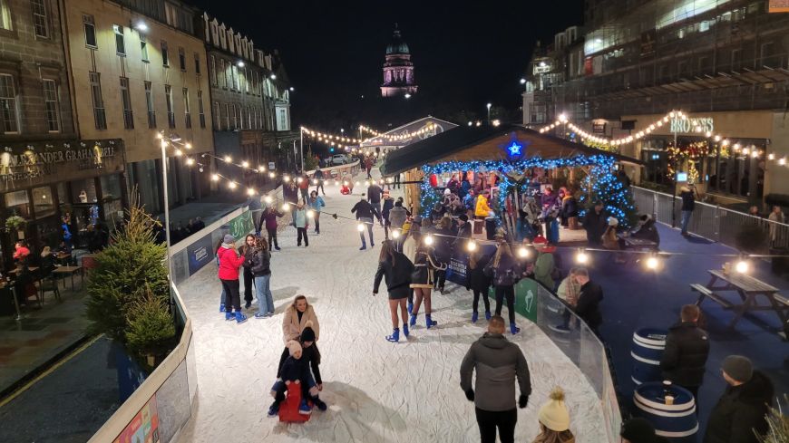 Christmas skaters on Edinburgth's temporary rink on George street