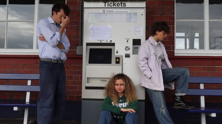The cast at a railway station to dramatise a scene from No Time For Strangers 