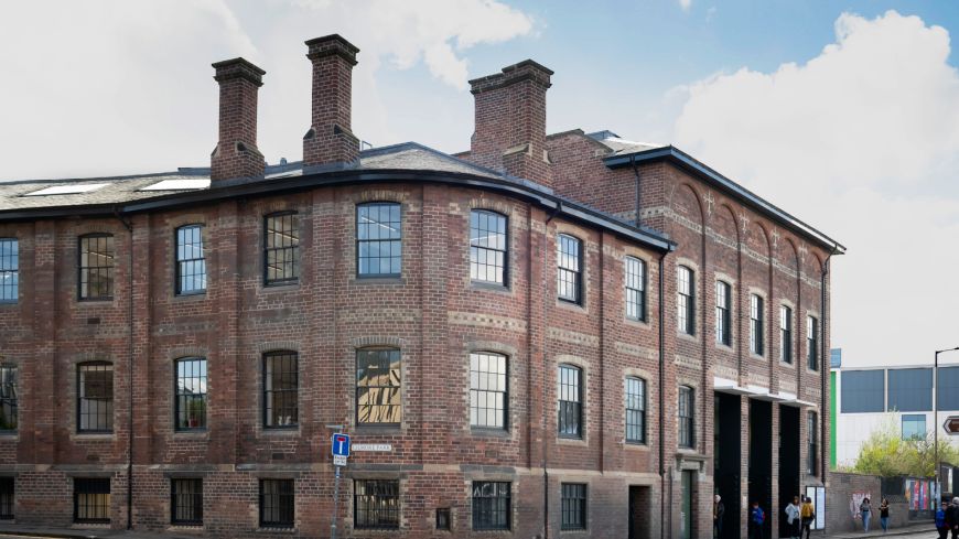 Exterior of Edinburgh Printmakers, an industrial red-brick building on a main road