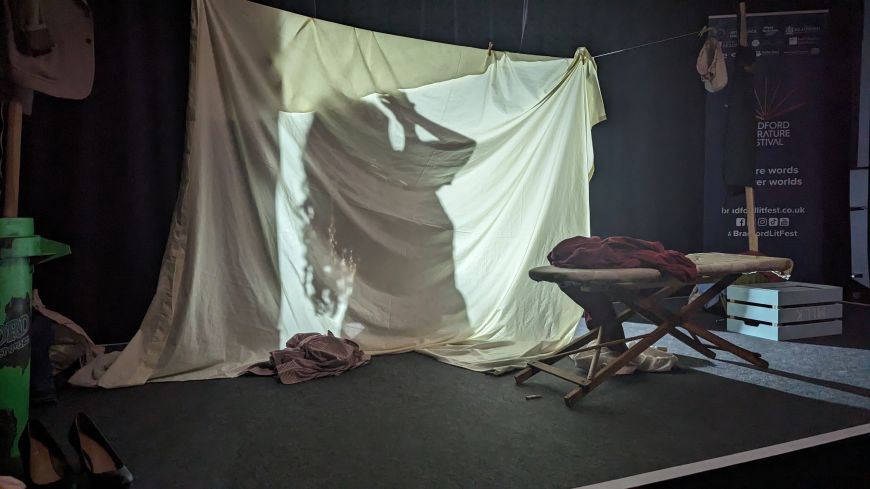 Screen made from a sheet; actor washes behind the screen while still talking.