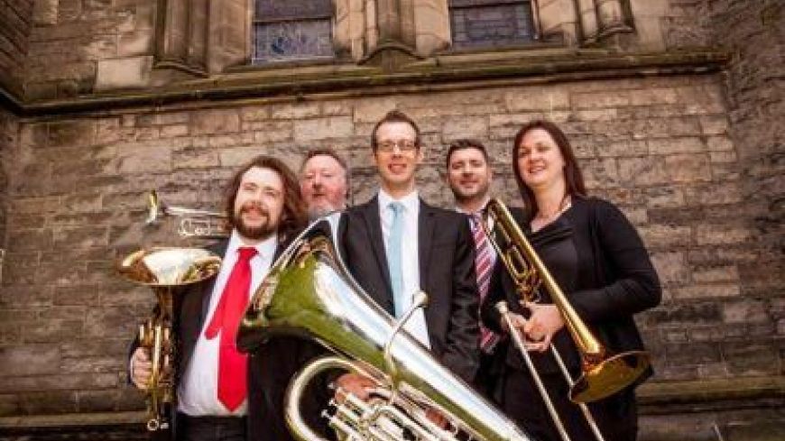 Photo of the five Brass Tracks members posing with their instruments