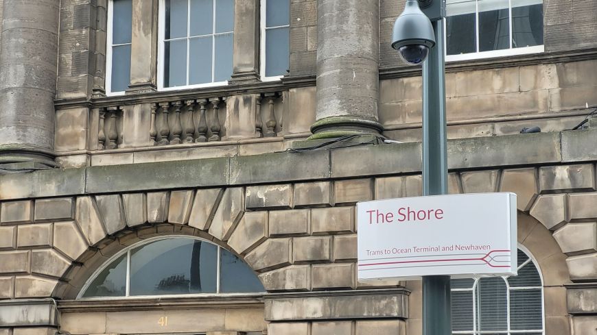 Edinburgh Trams sign at the Shore closeup with Georgian brickwork in background