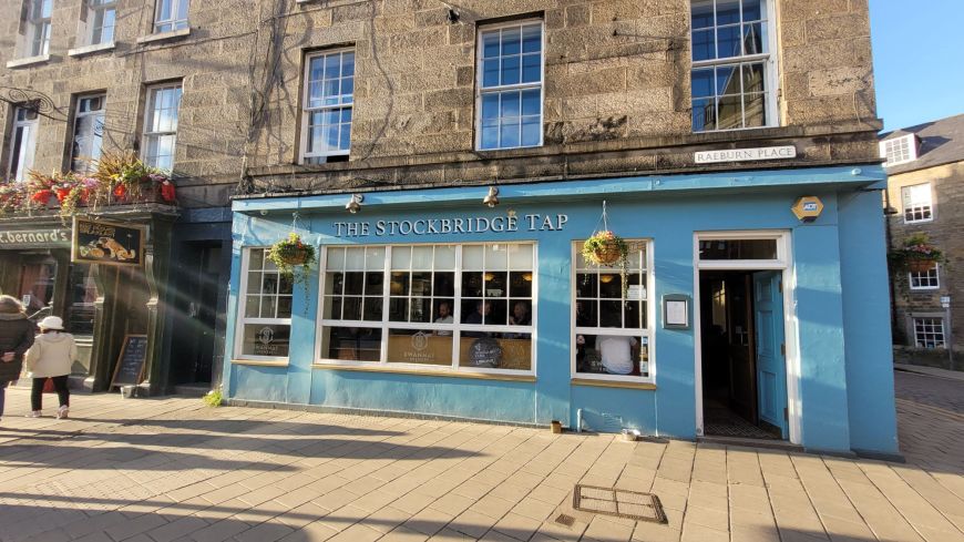 The turquoise frontage of the Stockbridge Tap pub on a sunny day in Spring