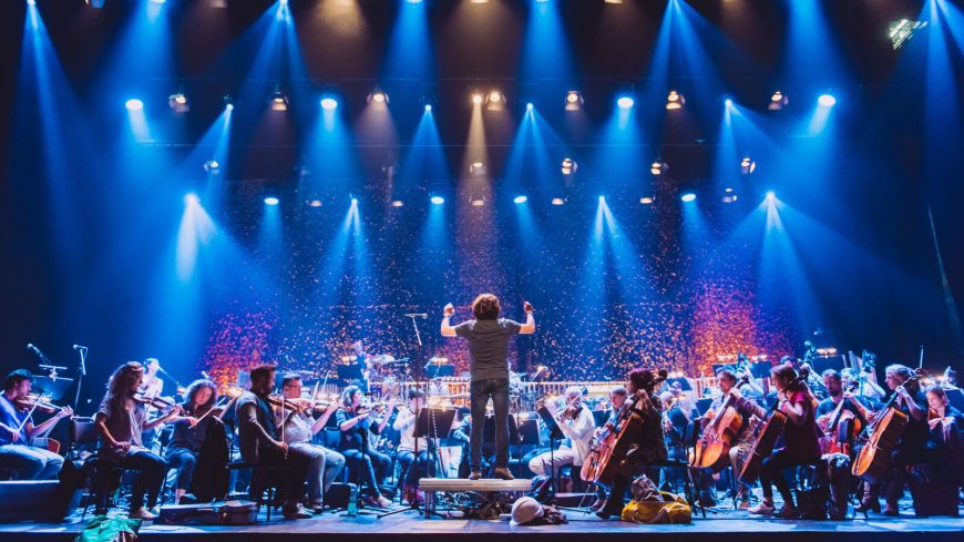 GRIT Orchestra performing under blue lights