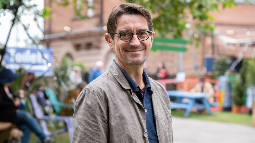 Edinburgh Book Festival Director Nick Barley stands in front of the Edinburgh College of Art building 