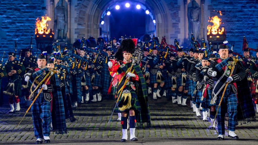 Regimental pipes and drums march through Edinburgh castle gate