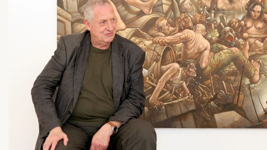 Peter Howson in front of one of his paintings