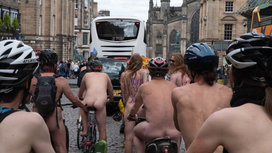 Rear shot of cyclists on the World Naked Bike Ride on the Royal Mile