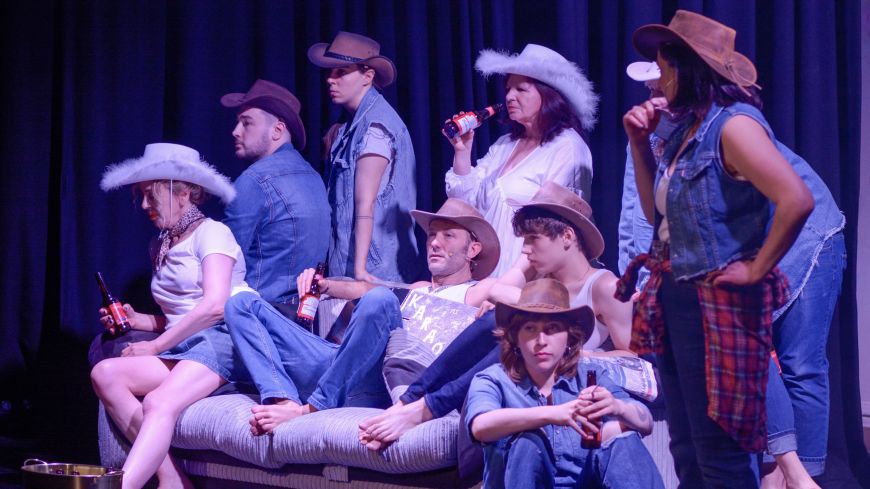 The cast of Common is as Common Does: A Memoir, pose on and around a sofa. All are wearing cowboy hats and denim.