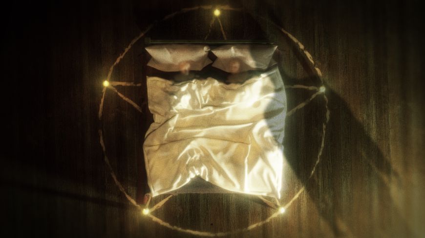 Shot above a bed which has a circle of light round it.