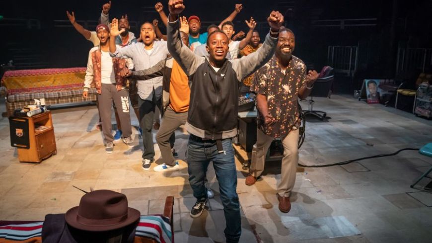 The cast of Barber Shop Chronicles gather round, bringing their energy and projecting it to the audience.