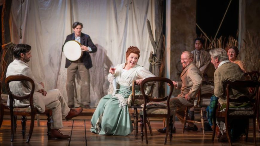 The Cast of The Seagull looking at each other jovially in the opening scene as they watch a performance