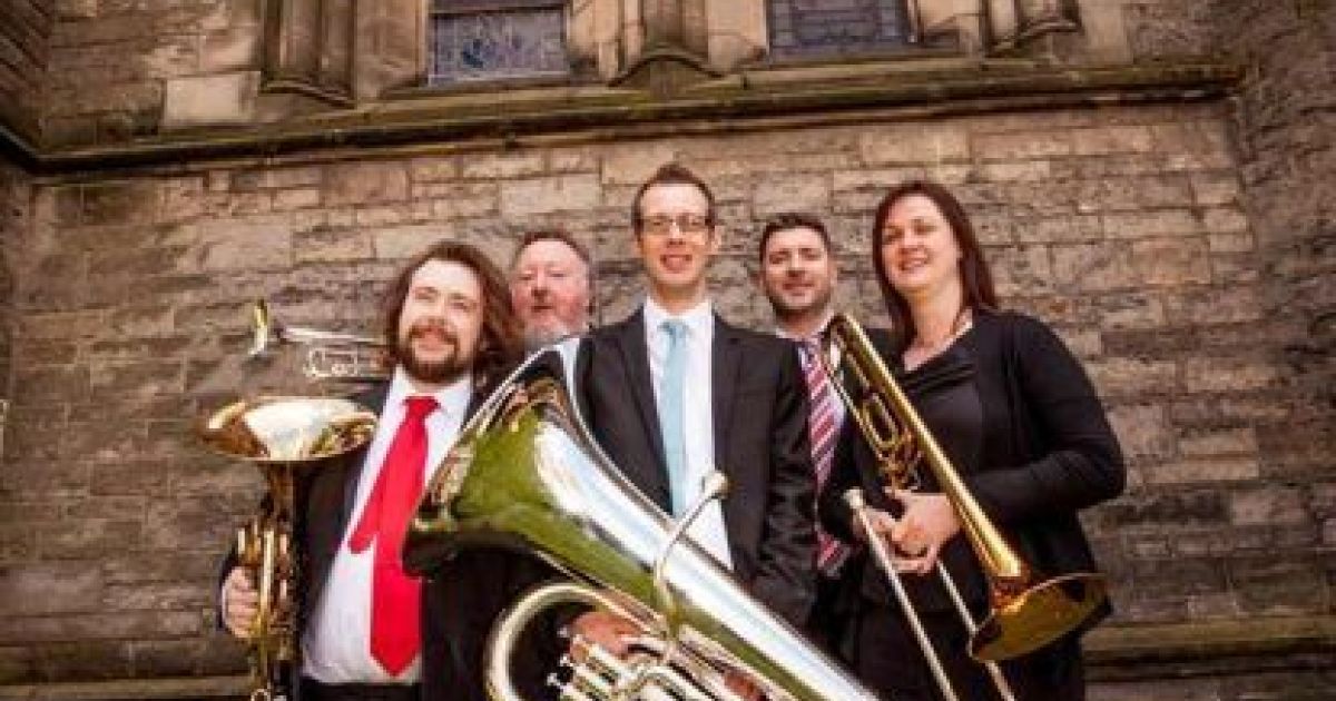 Photo of the five Brass Tracks members posing with their instruments