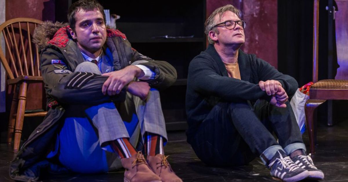 L-R: Nebli Basani and Paul McCole, sitting on the ground considering the challenges in their lives. Photographer Lara Cappelli.
